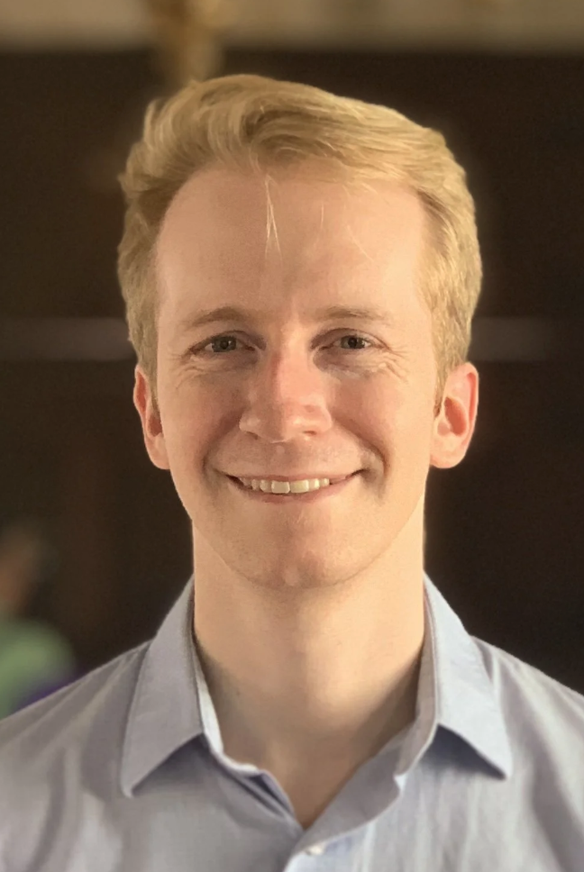 White man with blond hair, smiling