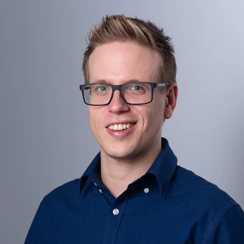 A blond man with glasses