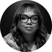 Wendy Calhoun, a Black woman with large glasses, bangs, and long hair