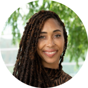Brielle Ferguson, a black woman with long hair twists, smiling