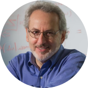 A white man with curly gray hair, beard, and glasses