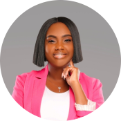 A black woman with a sharp bob, smiling