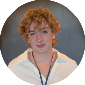 A person with curly red hair, smiling